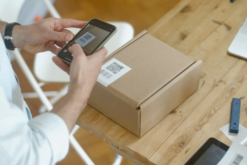 Person scanning parcel QR code